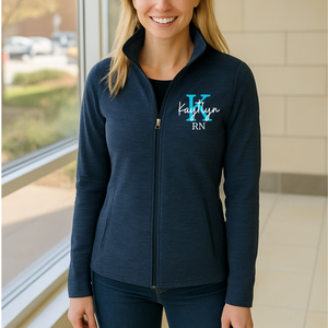 Person wearing a navy blue jacket with personalized text on a blurred indoor background