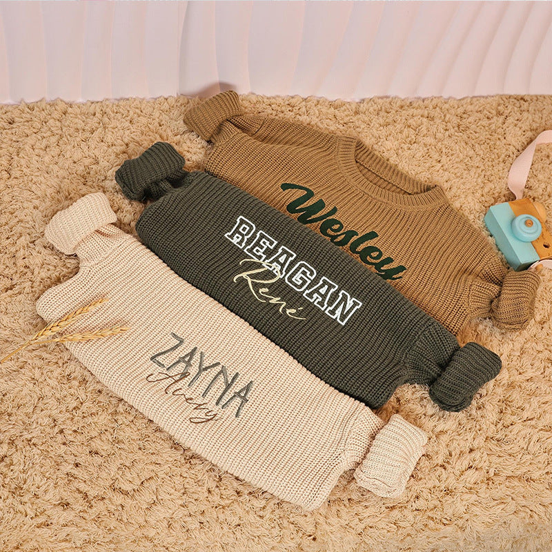 Three personalized knit sweaters embroidered with Wesley, Reagan Renรฉ and Zayna