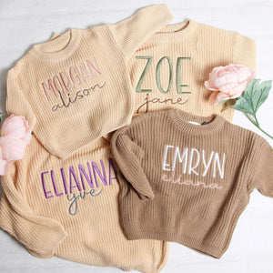 Personalized name sweaters in cream and tan with two-tone embroidery