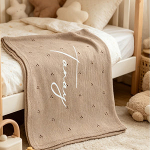Tan eyelet knit blanket embroidered with Tanay in white script