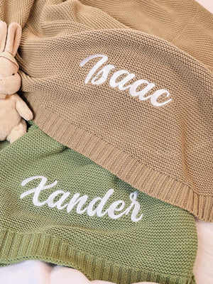 Sage and tan knit blankets embroidered with Isaac and Xander