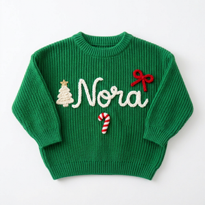Hand embroidered Christmas tree, bow & candy cane Christmas sweater on a plain background