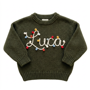 Hand embroidered string lights name Christmas sweater on a plain background