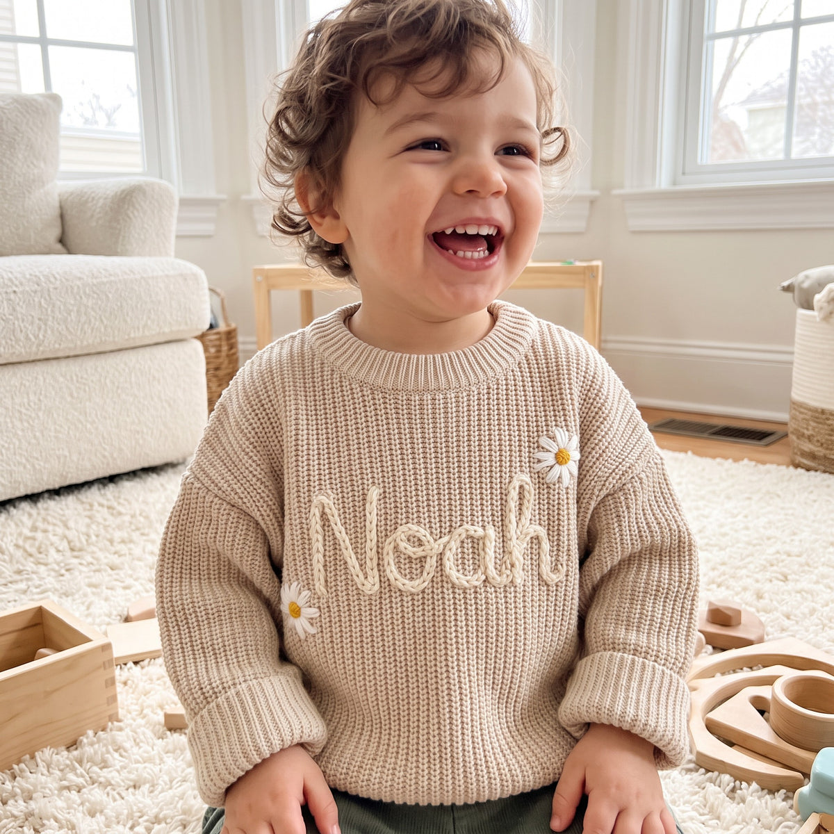 Toddler wearing a personalized hand embroidered name sweater