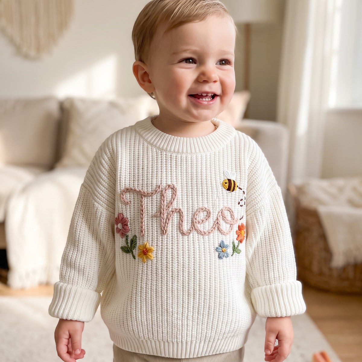 Toddler wearing a personalized hand embroidered name sweater