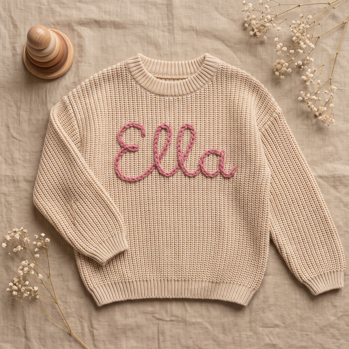 Hand Embroidered Name Sweater for Babies โ flat lay