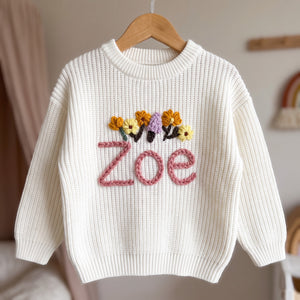 Personalized kids sweater on a wooden hanger