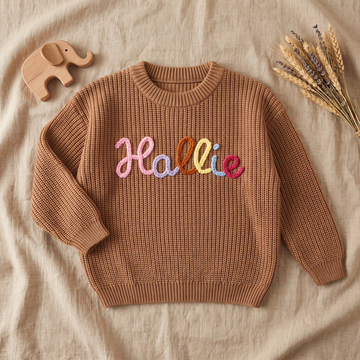 Rainbow Yarn Name Sweater โ flat lay