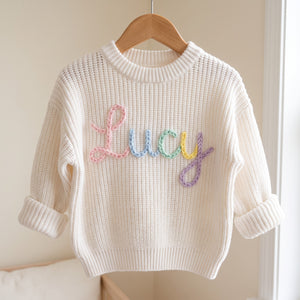 Personalized kids sweater on a wooden hanger