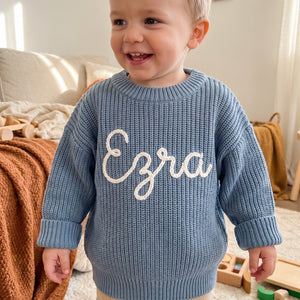 Toddler wearing a personalized hand embroidered name sweater