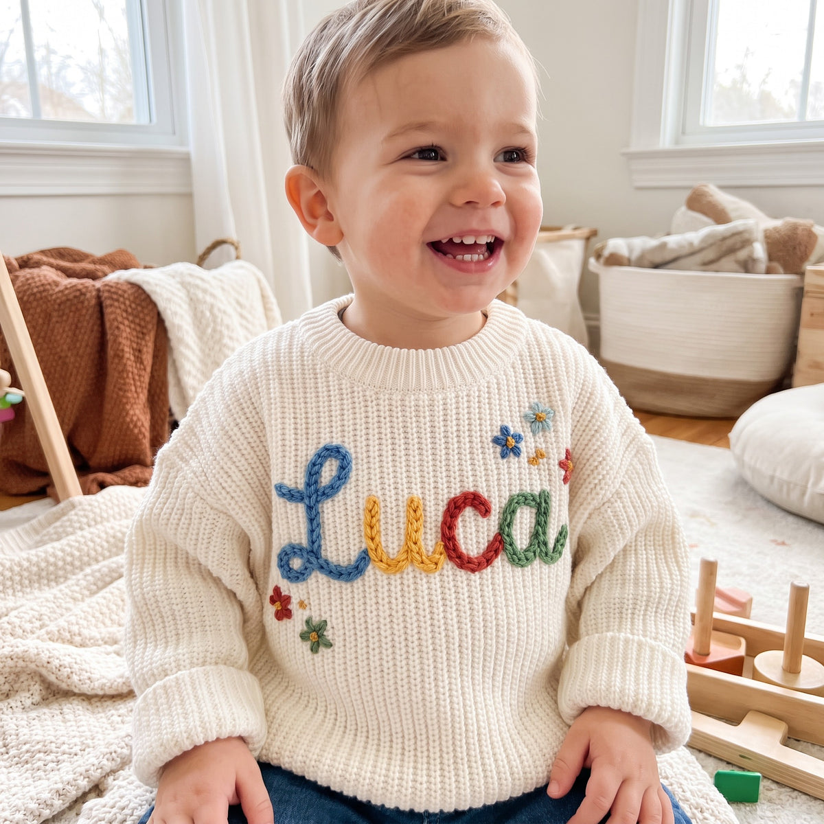 Toddler wearing a personalized hand embroidered name sweater