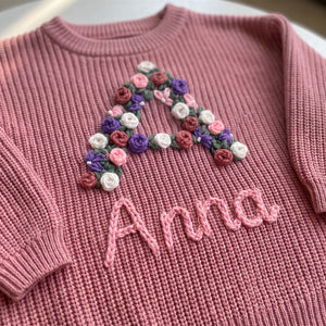 Close-up of hand embroidered chain stitch name on chunky knit