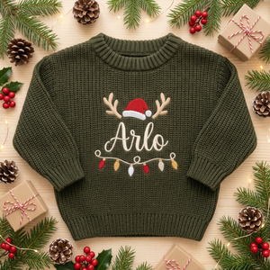 Machine embroidered reindeer antlers, Santa hat & lights baby Christmas sweater among Christmas decorations