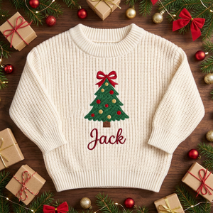 Machine embroidered Christmas tree with bow topper baby Christmas sweater among Christmas decorations