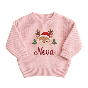 Machine embroidered baby reindeer with Santa hat baby Christmas sweater on a plain background