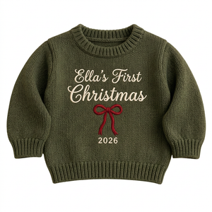 Machine embroidered first Christmas with bow baby Christmas sweater on a plain background