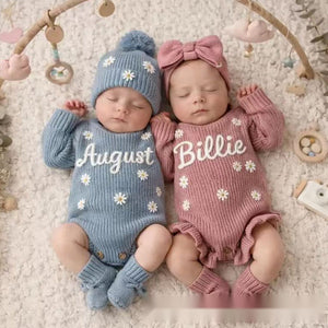 Two babies in knit rompers embroidered with August and Billie