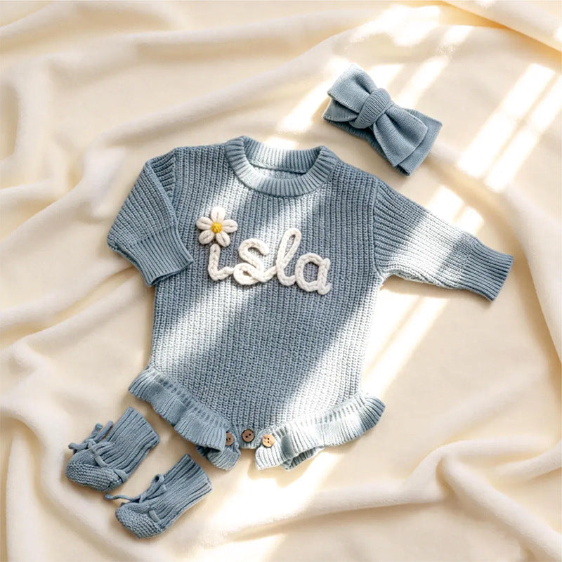 Gray blue knit baby romper embroidered with the name Isla and a daisy