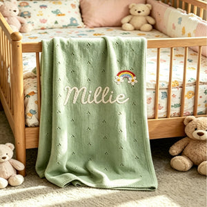 Green eyelet knit blanket embroidered with Millie and a rainbow