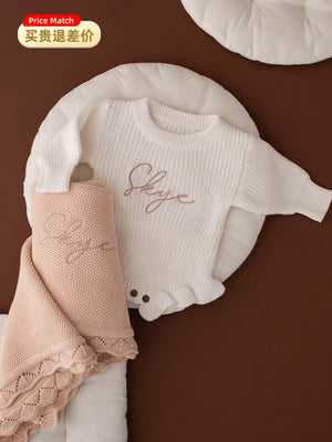 White ruffle knit baby romper embroidered with the name Skye