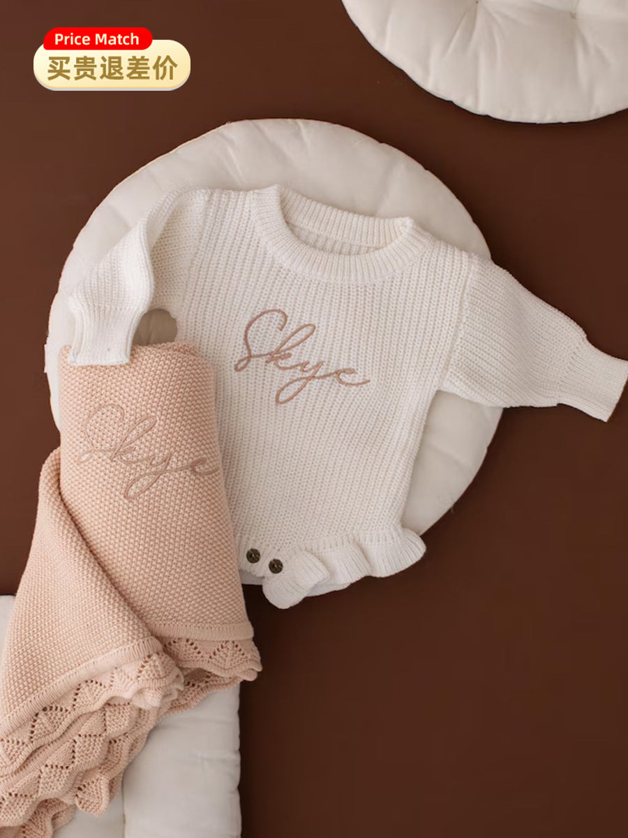 White ruffle knit baby romper embroidered with the name Skye