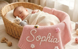 Pink knit baby blanket hand-embroidered with Sophia and small flowers