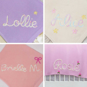 Four knit blankets embroidered with Lollie, Alice, Brielle and Rosie with small motifs