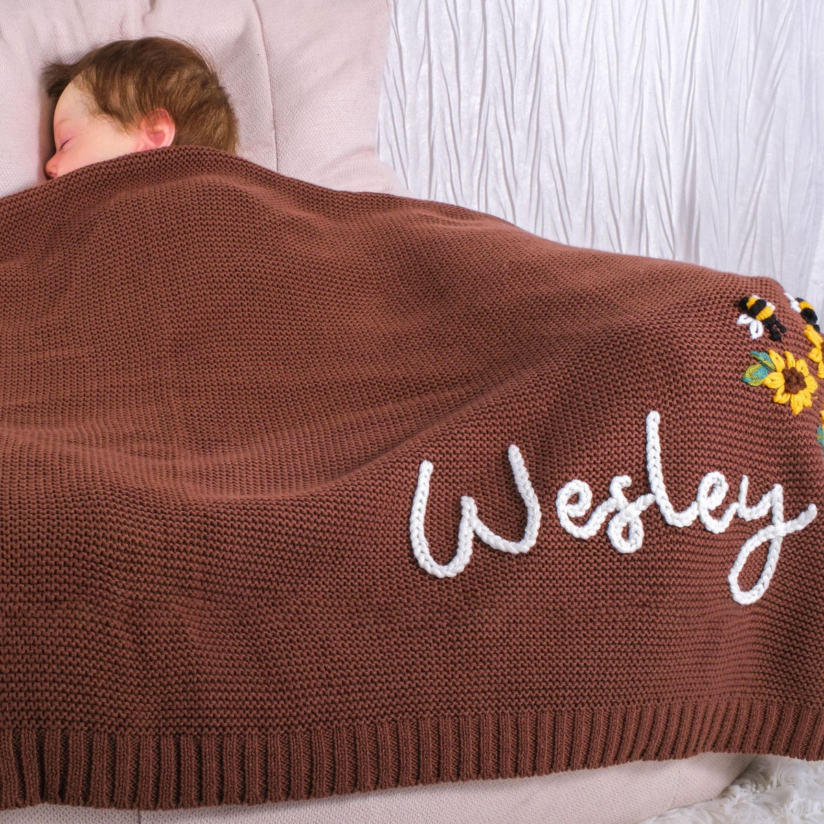 Brown knit blanket embroidered with Wesley and a sunflower