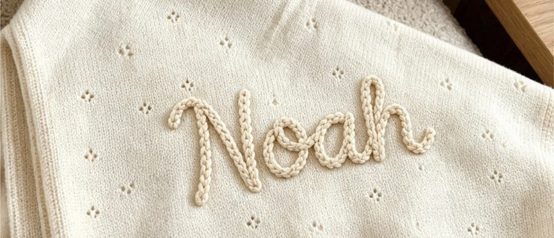 Cream pointelle blanket embroidered with Noah in chunky yarn