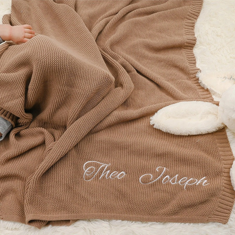 Brown knit baby blanket embroidered with Theo Joseph
