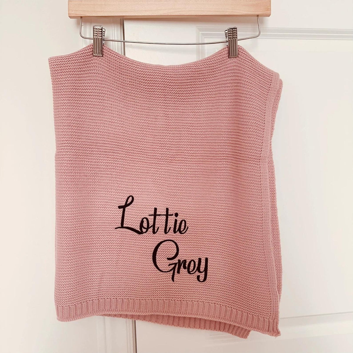 Pink knit baby blanket embroidered with Lottie Grey