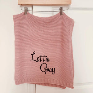 Pink knit baby blanket embroidered with Lottie Grey