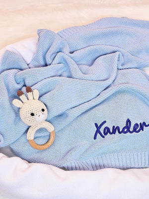 Light blue knit blanket embroidered with Xander in navy