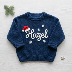 Personalized baby Christmas sweater, hand embroidered santa hat & snowflakes, flat lay