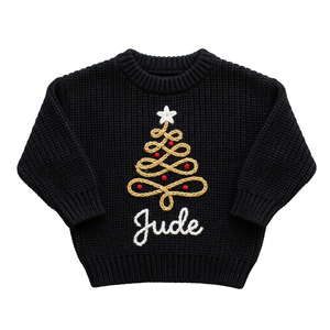 Hand embroidered gold swirl Christmas tree Christmas sweater on a plain background