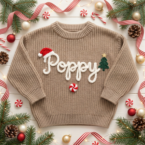 Personalized Christmas sweater with hand embroidered santa hat, tree & peppermint among Christmas decorations