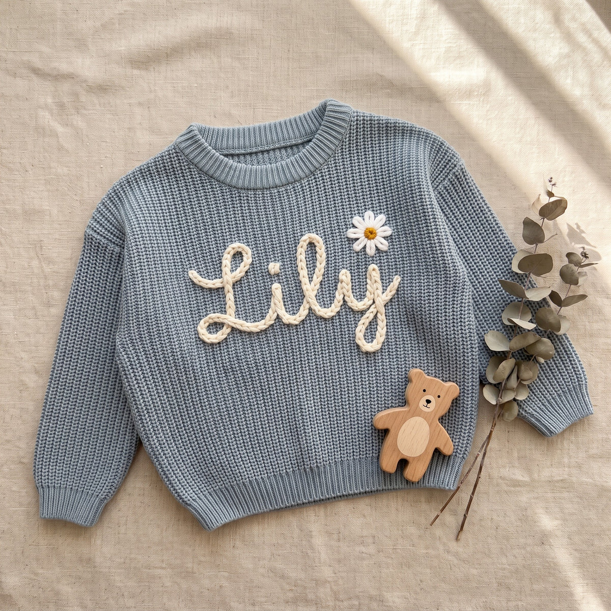 Personalized Baby Name Sweater – flat lay