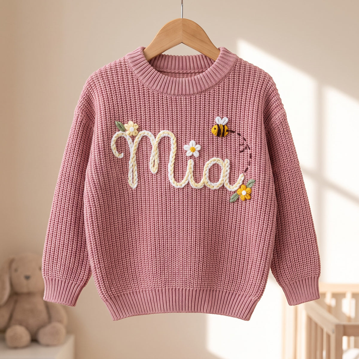 Personalized kids sweater on a wooden hanger
