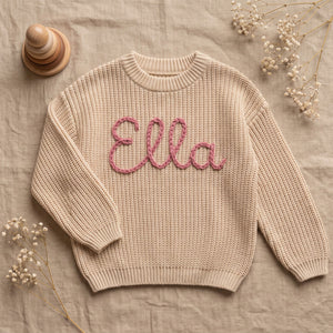 Hand Embroidered Name Sweater for Babies – flat lay