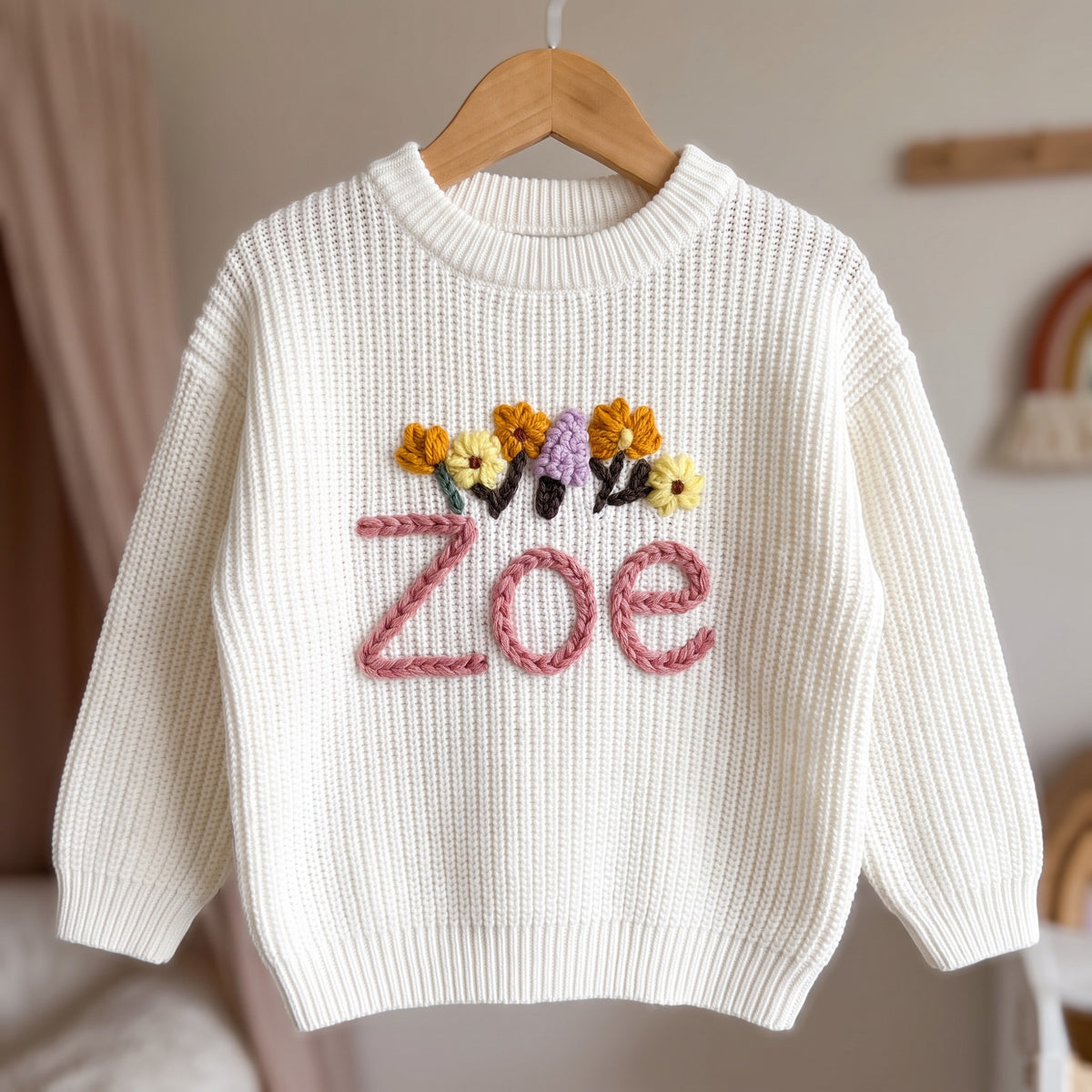 Personalized kids sweater on a wooden hanger