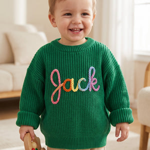 Toddler wearing a personalized hand embroidered name sweater