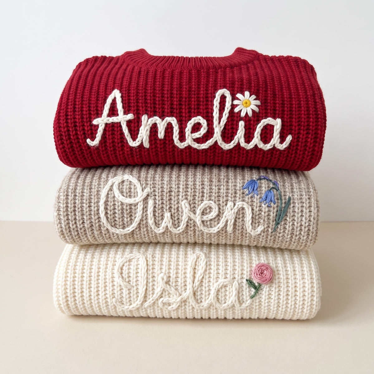 Hand embroidered name sweaters in three knit colors