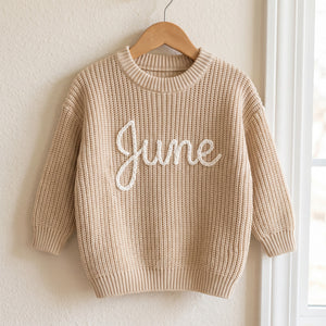 Personalized kids sweater on a wooden hanger