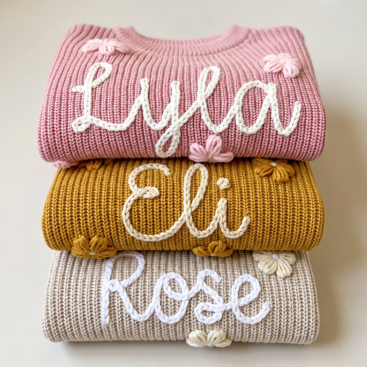 Hand embroidered name sweaters in three knit colors