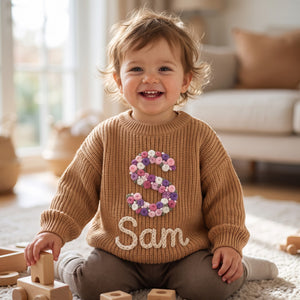 Toddler wearing a personalized hand embroidered name sweater