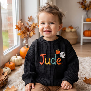 Toddler wearing a personalized hand embroidered name sweater