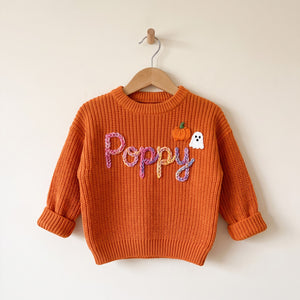 Personalized kids sweater on a wooden hanger