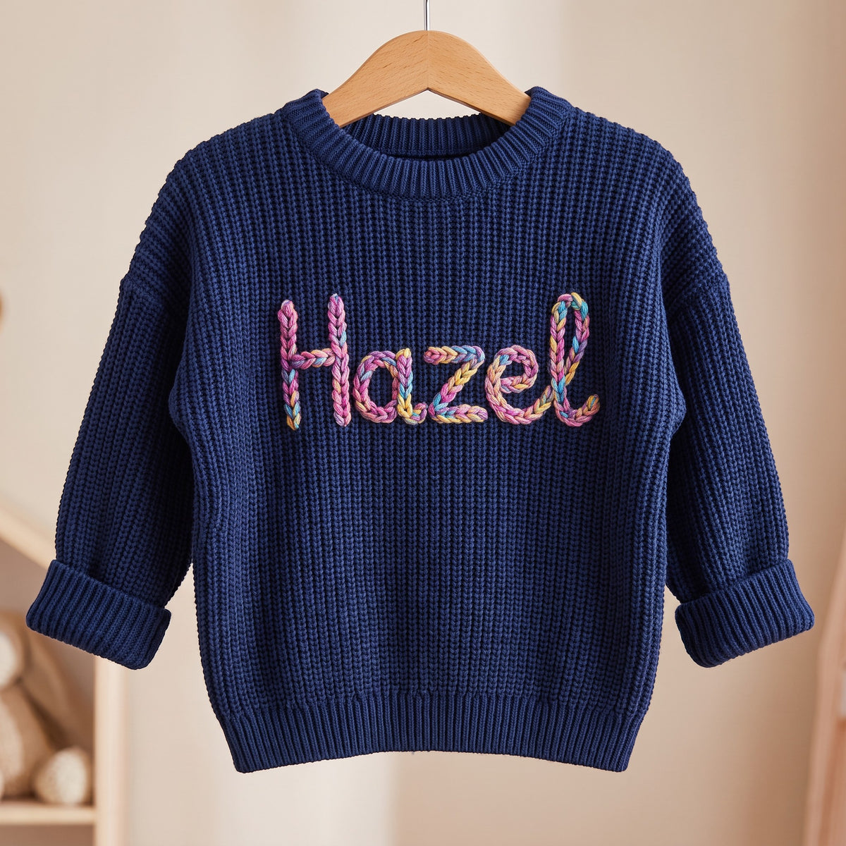 Personalized kids sweater on a wooden hanger