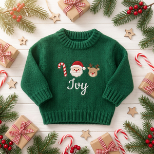 Machine embroidered candy cane, Santa & reindeer baby Christmas sweater among Christmas decorations