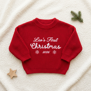 Machine embroidered first Christmas script baby Christmas sweater, flat lay